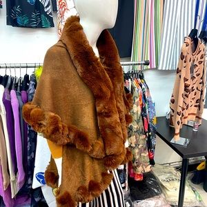 Glamorous Faux Fur trimmed cape available in several colors.